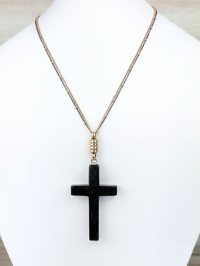 Laurel is an upcycled Bakelite cross from the 1930s. She made her way through time in fine condition with no nicks, scratches, or "fleabites". The color looks black, but it's super dark green with swirls of teal and gold.  The cross is suspended from a rose gold fill link. The calming beauty of simple, structured lines. Bakelite is weightless and easy to wear.