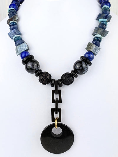Wear Nobilis as a reminder to be true to yourself. A shungite disc pendant is suspended from antique Victorian gutta percha links. The shungite pendant is approximately 1 1/2 inches and the drop is about 3 1/2 inches.