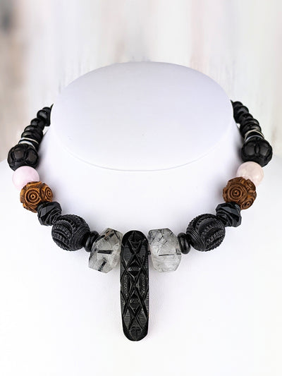 Renza summons her Victorian dark materials. The pendant, circa 1890, is a handcrafted design made from Whitby jet, a favorite material of Queen Victoria. Many of the beads featured here also hail from Victorian England.